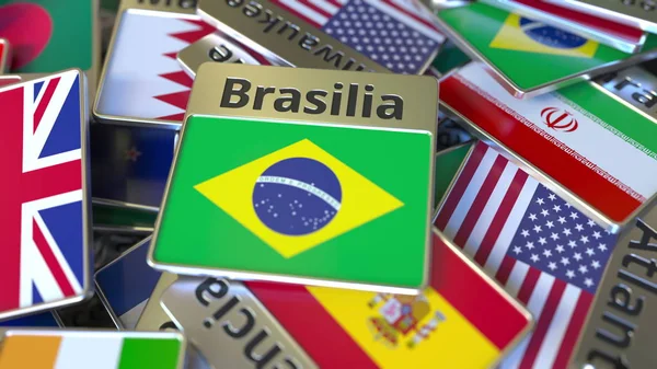 Сувенирный магнит или значок с текстом Бразилиа и национальным флагом среди различных. Путешествие в Бразилию концептуальный 3D-рендеринг — стоковое фото