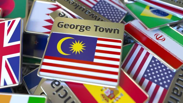 Ímã de lembrança ou crachá com texto de George Town e bandeira nacional entre diferentes. Viajando para a Malásia conceitual 3D renderização — Fotografia de Stock