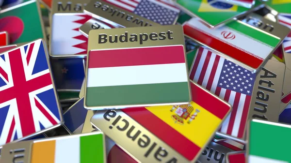 Ímã de lembrança ou crachá com texto de Budapeste e bandeira nacional entre diferentes. Viajar para a Hungria renderização 3D conceitual — Fotografia de Stock