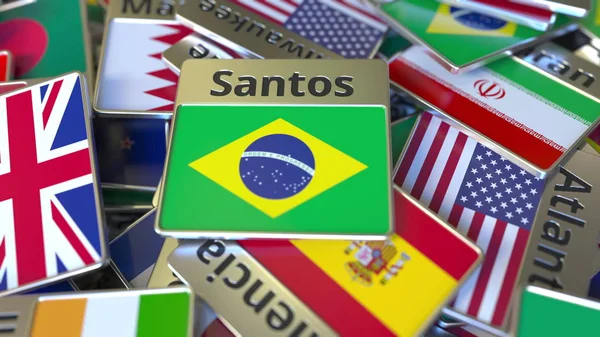 Сувенирный магнит или значок с текстом Сантоса и национальным флагом среди разных. Путешествие в Бразилию концептуальный 3D-рендеринг — стоковое фото