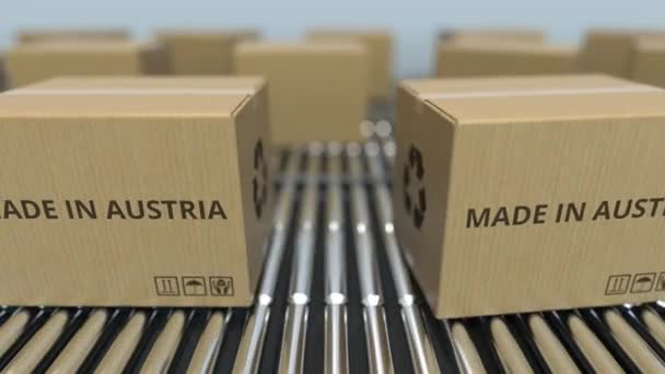 Cajas con texto MADE IN AUSTRIA sobre transportador de rodillos. Animación 3D loopable relacionada con productos venezolanos — Vídeos de Stock