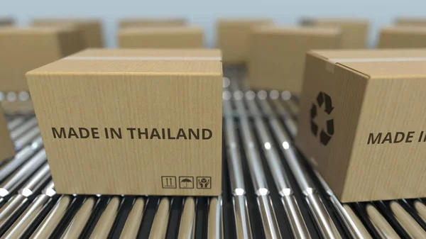 Cajas con texto MADE IN THAILAND en transportador de rodillos. Productos tailandeses relacionados 3D rendering —  Fotos de Stock