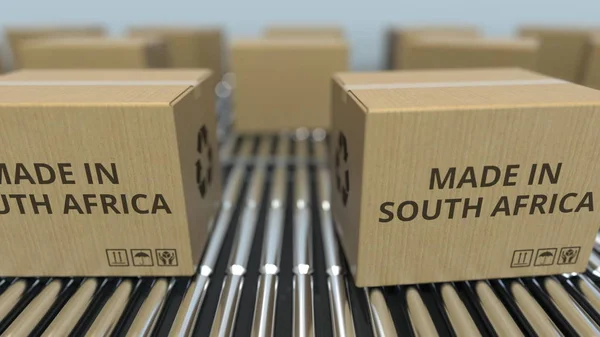 Cajas con texto MADE IN SOUTH AFRICA sobre transportador de rodillos. renderizado 3D relacionado con mercancías —  Fotos de Stock