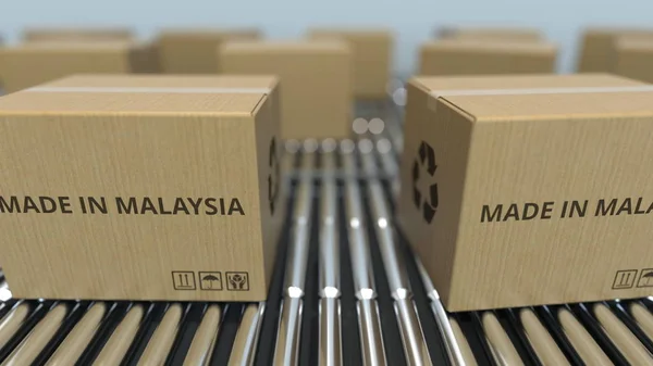 在滚筒传送带上带有马来西亚制造的文本的盒子。马来西亚商品相关 3D 渲染 — 图库照片