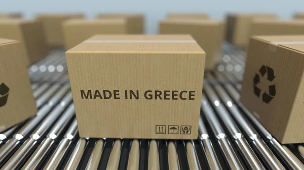 Cajas con texto MADE IN GREECE en transportador de rodillos. Productos griegos relacionados con la representación 3D —  Fotos de Stock