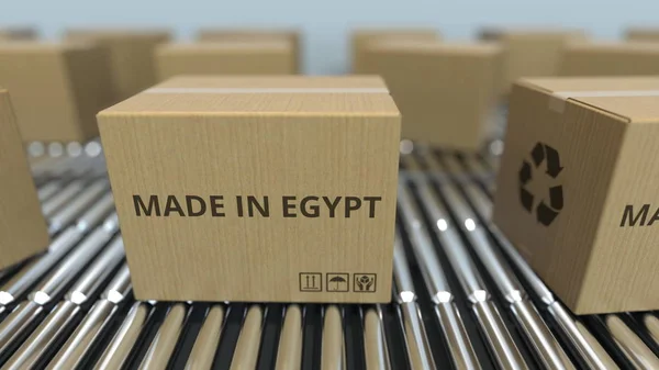 在滚筒传送带上带有埃及制造文本的盒子。埃及商品相关 3D 渲染 — 图库照片