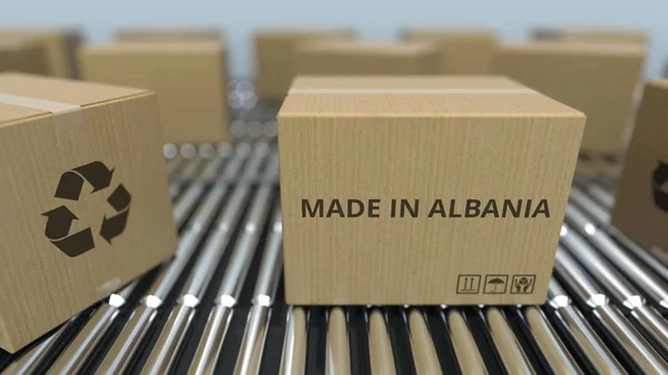 在滚筒传送带上带有阿尔巴尼亚制造的盒子文本。阿尔巴尼亚商品相关3D渲染 — 图库照片