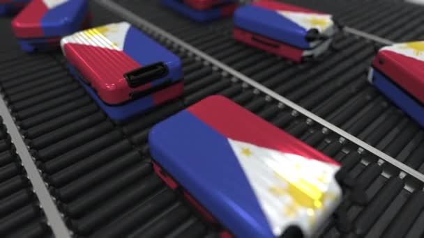 De nombreuses valises de voyage portant le drapeau des Philippines sur un convoyeur à rouleaux. Animation conceptuelle liée au tourisme — Video