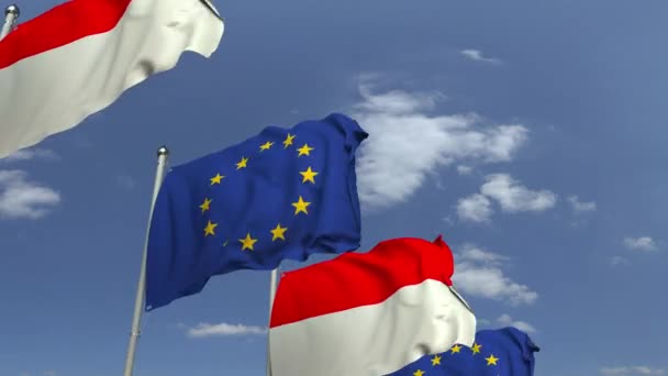 Vlaggen van Indonesië en de Europese Unie tegen Blue Sky, loop bare 3D-animatie — Stockvideo