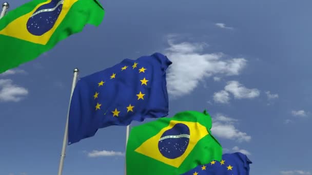 Waving flags of Brazil and the EU on sky background, loopable 3D animation — Stock Video