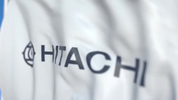 Waving flaga z Hitachi, Ltd. logo, zbliżenie. Redakcyjnej pętli animacji 3D — Wideo stockowe