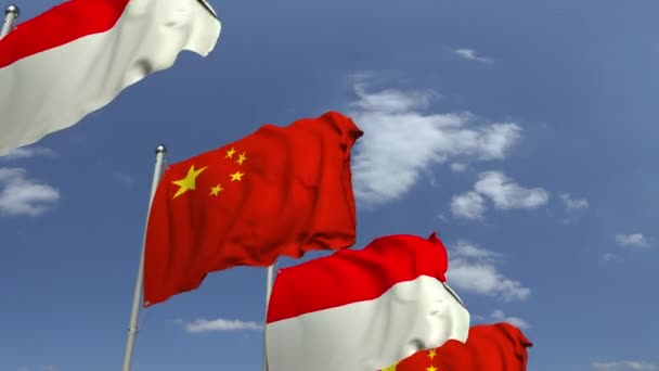 Drapeaux de l'Indonésie et de la Chine contre le ciel bleu, animation 3D en boucle — Video