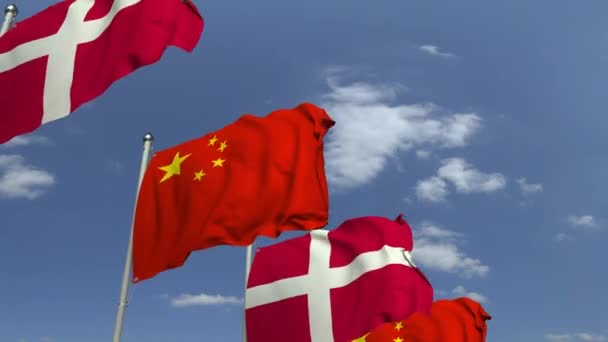 Waving flags of Denmark and China on sky background, loopable 3D animation — Stock Video