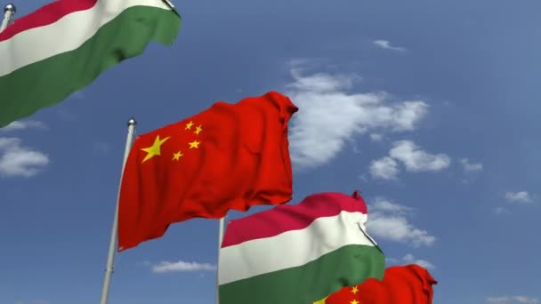 Ряд размахивания флагами Венгрии и Китая, зацикленная 3D анимация — стоковое видео