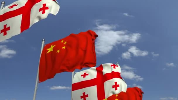 Zwaaiende vlaggen van Georgië en China op Sky achtergrond, loop bare 3D-animatie — Stockvideo