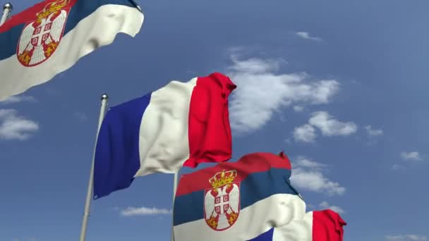 Waving flags of Serbia and France on sky background, loopable 3D animation — Stock Video