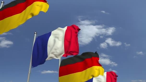 Waving flags of Germany and France on sky background, loopable 3D animation — Stock Video