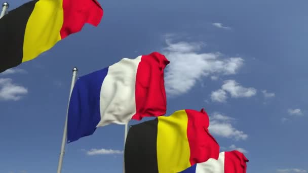 Flags of Belgium and France against blue sky, loopable 3D animation — Stock Video