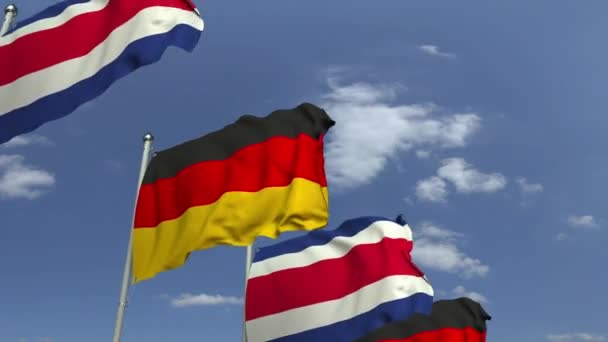 Розмахуючи прапорами Коста-Ріки та Німеччини на тлі неба, лумяка 3D анімація — стокове відео