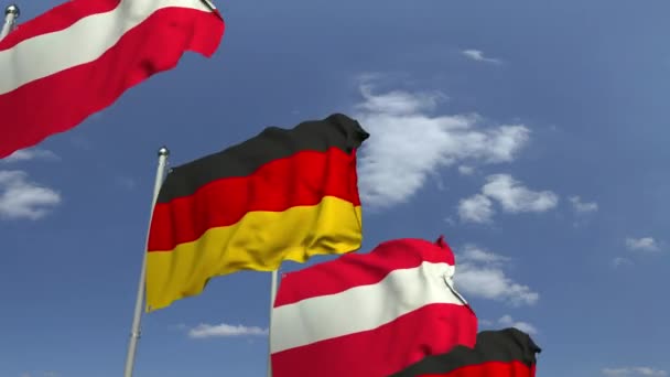 Ondeando banderas de Austria y Alemania en el fondo del cielo, animación 3D loopable — Vídeo de stock