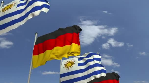 青空に対するウルグアイとドイツの旗、ループ可能な3Dアニメーション — ストック動画