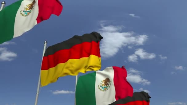 Ondeando banderas de México y Alemania en el fondo del cielo, animación 3D loopable — Vídeo de stock