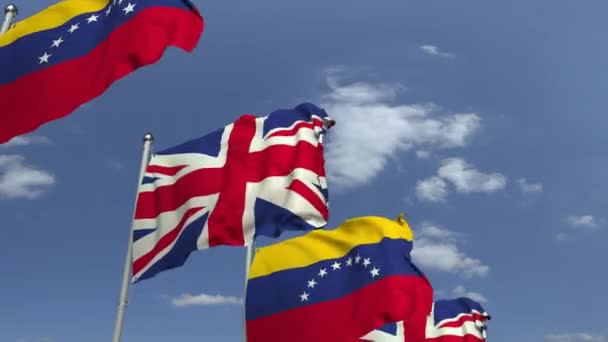 Waving flags of Venezuela and the United Kingdom on sky background, loopable 3D animation — Stock Video