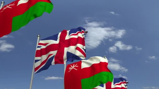 Omán és az Egyesült Királyság zászlói nemzetközi találkozón, loopable 3D animáció — Stock videók