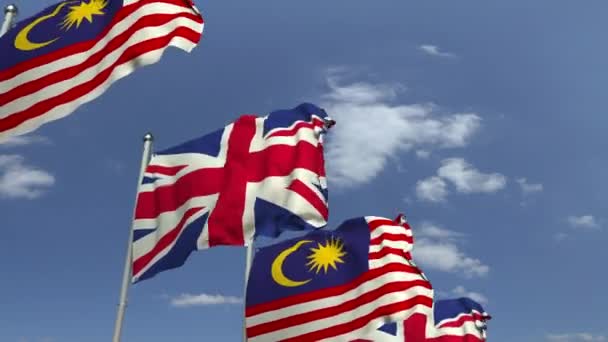 Mavi gökyüzüne karşı Malezya ve Birleşik Krallık bayrakları, döngülü 3d animasyon — Stok video