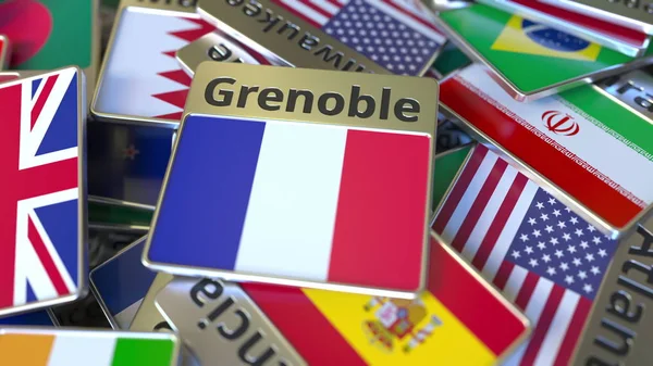 Ímã de lembrança ou crachá com texto Grenoble e bandeira nacional entre diferentes. Viajar para a França renderização 3D conceitual — Fotografia de Stock