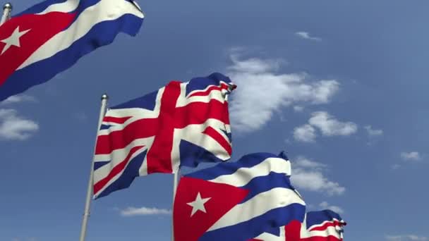 Banderas de Cuba y el Reino Unido contra el cielo azul, animación 3D loopable — Vídeo de stock