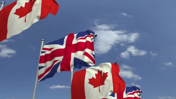 Fila de banderas ondeantes de Canadá y el Reino Unido, animación 3D loopable — Vídeo de stock