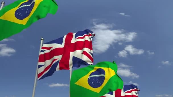 Ondeando banderas de Brasil y el Reino Unido en el fondo del cielo, animación 3D loopable — Vídeos de Stock