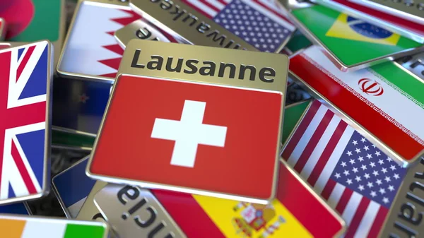 Ímã de lembrança ou crachá com texto de Lausanne e bandeira nacional entre diferentes. Viajar para a Suíça renderização 3D conceitual — Fotografia de Stock