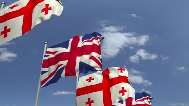 Σημαίες της γεωργίας και του Ηνωμένου Βασιλείου κατά του γαλάζιου ουρανού, loopable 3D κινούμενα σχέδια — Αρχείο Βίντεο