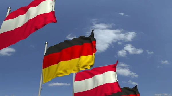 Ondeando banderas de Austria y Alemania en el fondo del cielo, representación 3D — Foto de Stock