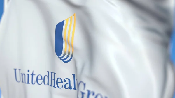 Bandeira acenando com o logotipo da UnitedHealth Group Incorporated, close-up. Renderização 3D editorial — Fotografia de Stock