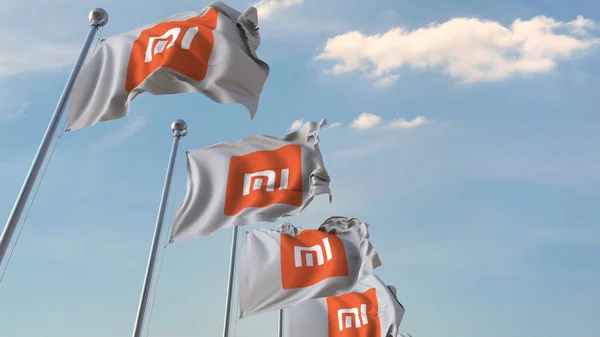 Wiersz macha flagi z logo Xiaomi Corporation. Redakcja renderowania 3D — Zdjęcie stockowe