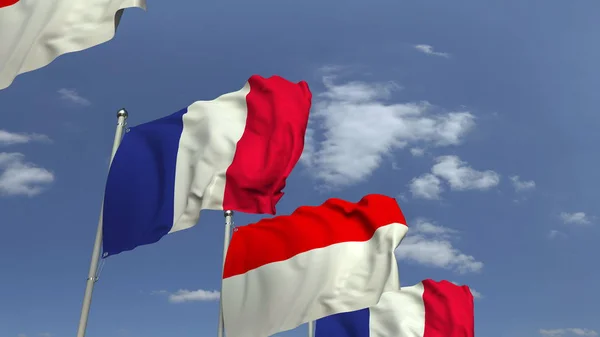 Indonézia és Franciaország zászlói kék ég ellen, 3D renderelés — Stock Fotó