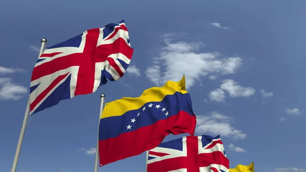 Ondeando banderas de Venezuela y el Reino Unido en el fondo del cielo, representación 3D —  Fotos de Stock