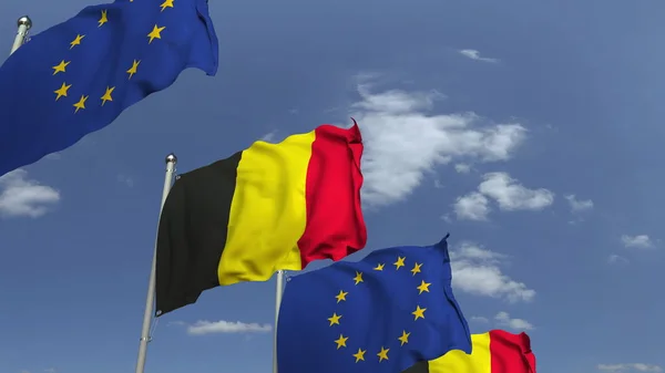 Flaggen Belgiens und der Europäischen Union vor blauem Himmel, 3D-Darstellung — Stockfoto