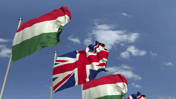 Fila de banderas ondeantes de Hungría y el Reino Unido, representación 3D — Foto de Stock