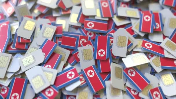 SIM-карты с флагом Северной Кореи. Концептуальная 3D анимация в корейской сотовой сети — стоковое видео