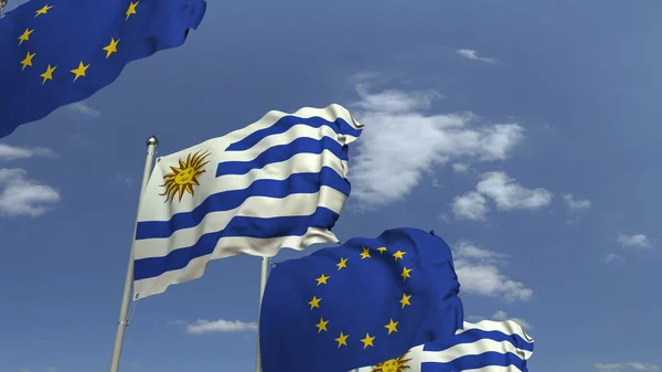 Uruguay és az Európai Unió kék égbolttal szembeni zászlóinak képtára, 3D renderelés — Stock Fotó