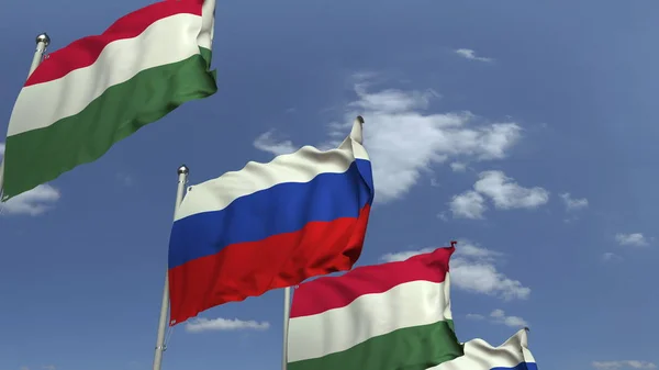 Fila de bandeiras acenando da Hungria e da Rússia, renderização 3D — Fotografia de Stock