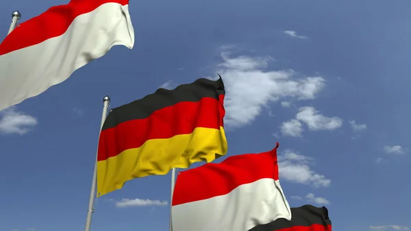 Прапори Індонезії та Німеччини проти синього неба, 3D візуалізації — стокове фото