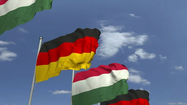 Řada mávající vlajky Maďarska a Německa, prostorové vykreslování — Stock fotografie