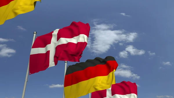 デンマークとドイツの旗を空の背景に振り、3Dレンダリング — ストック写真