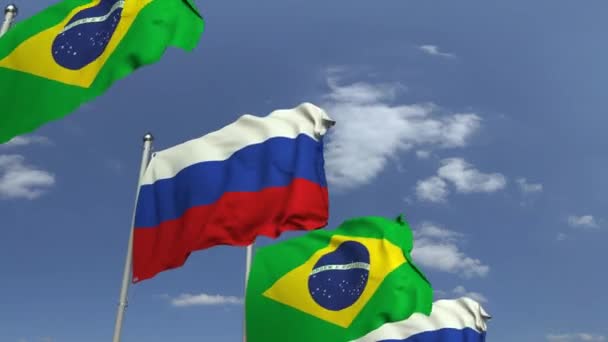 Zwaaiende vlaggen van Brazilië en Rusland op Sky achtergrond, loop bare 3D-animatie — Stockvideo