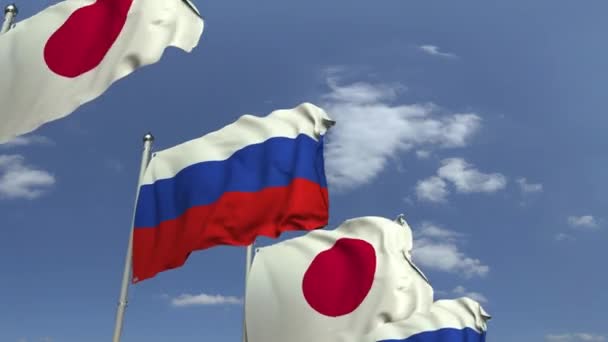 Много флагов Японии и России, петляющая 3D анимация — стоковое видео